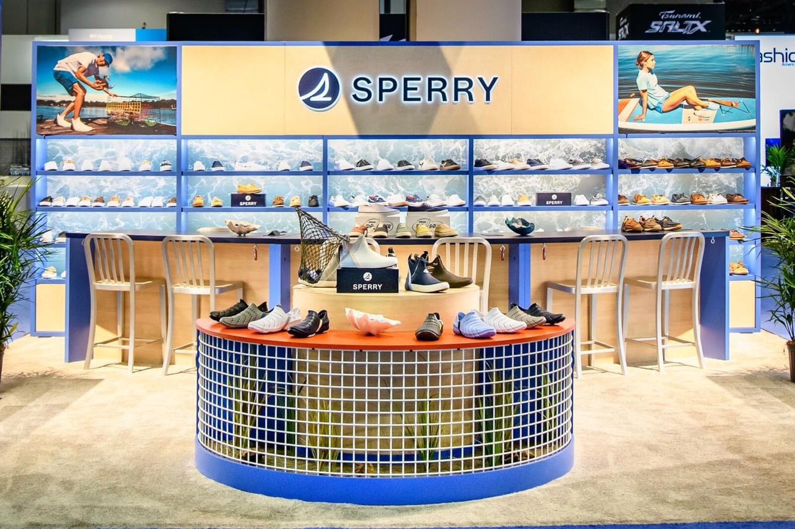 Wide product wall with a backlit brand header and a curved central display counter